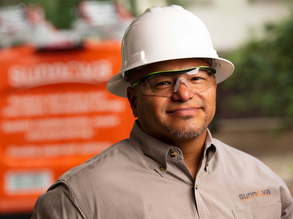 a person wearing a hard hat and glasses