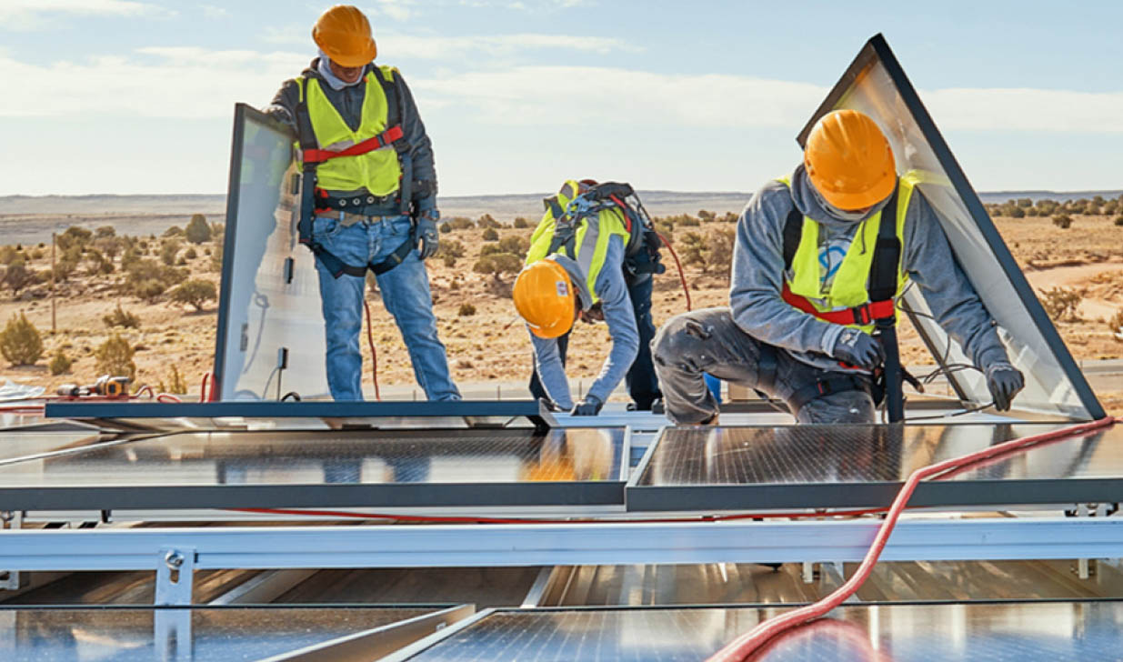 workers installing solar panels